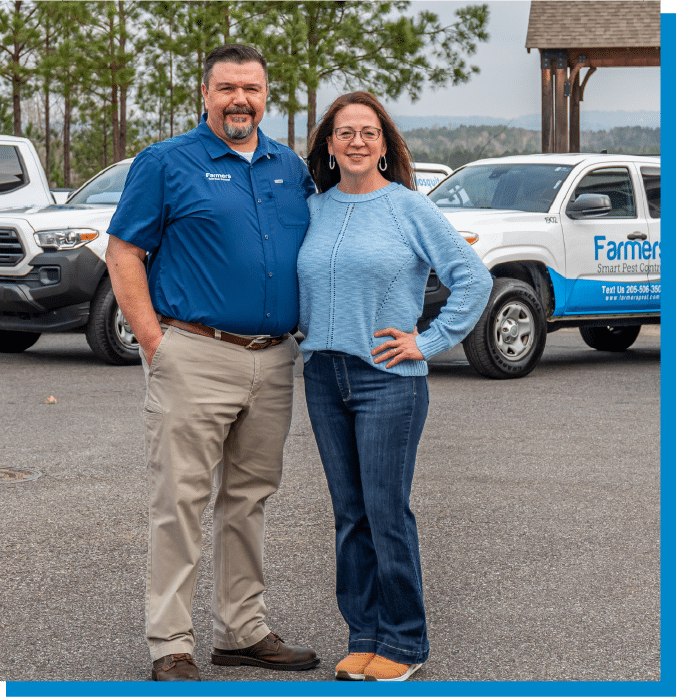 a man standing in front of a blue car