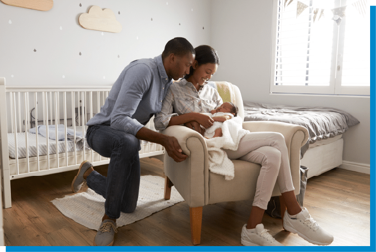 Parents lovingly holding their newborn baby in a bright and cozy nursery