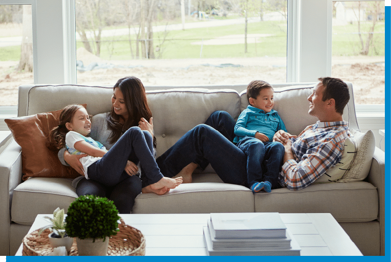 Happy family relaxing and laughing together on a living room couch