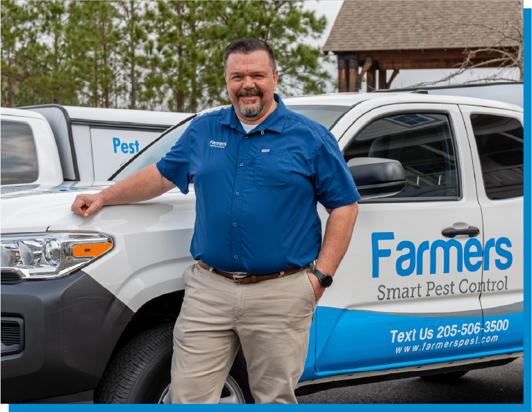 a man standing in front of a blue car
