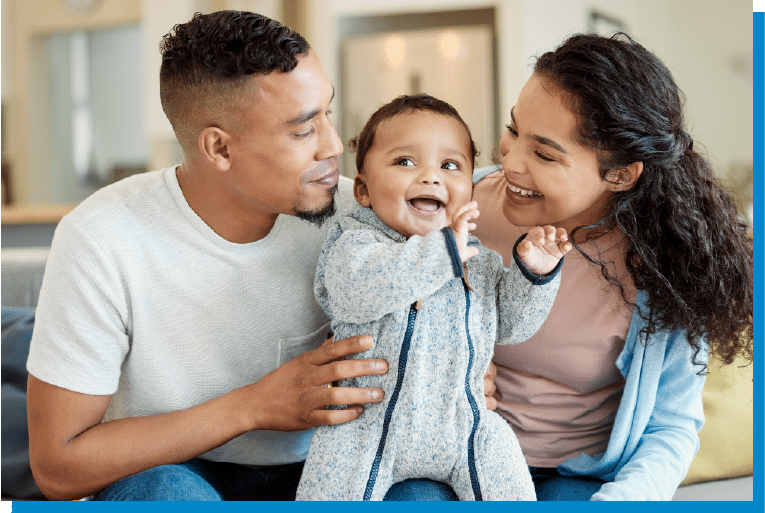 Smiling parents holding their happy baby during a warm family moment at home