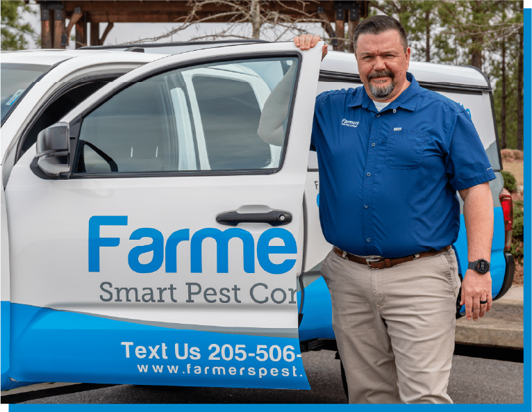 a man standing in front of a blue car