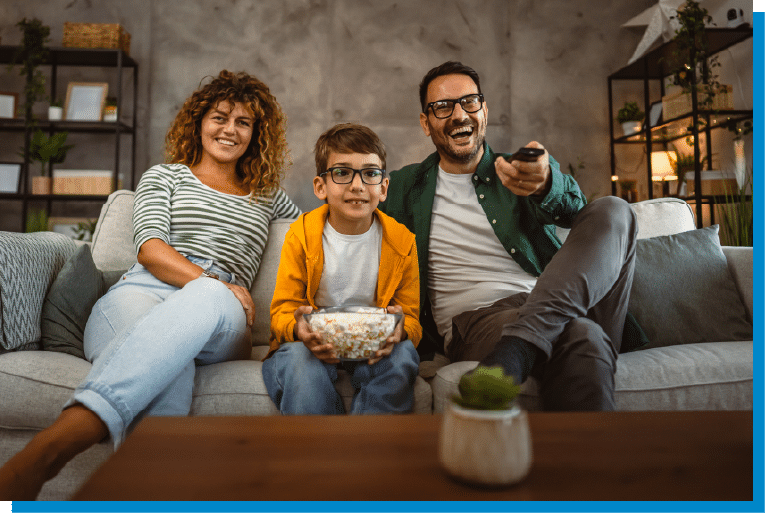 Family enjoying movie night together on the living room couch