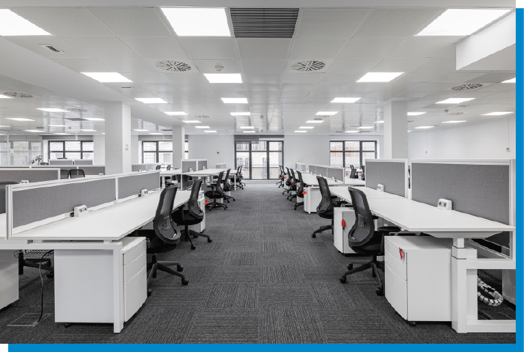 Modern open-plan office with clean workstations and ergonomic chairs